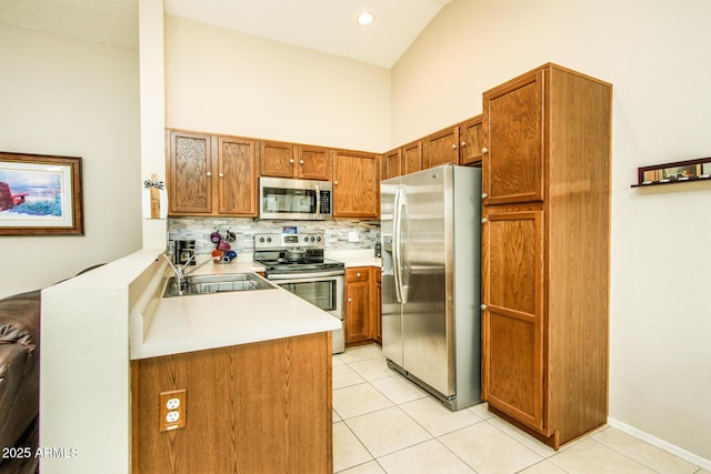 kitchen with light tile patterned flooring, appliances with stainless steel finishes, sink, and decorative backsplash