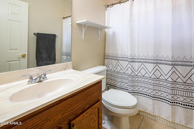 bathroom featuring vanity, tile patterned floors, and toilet