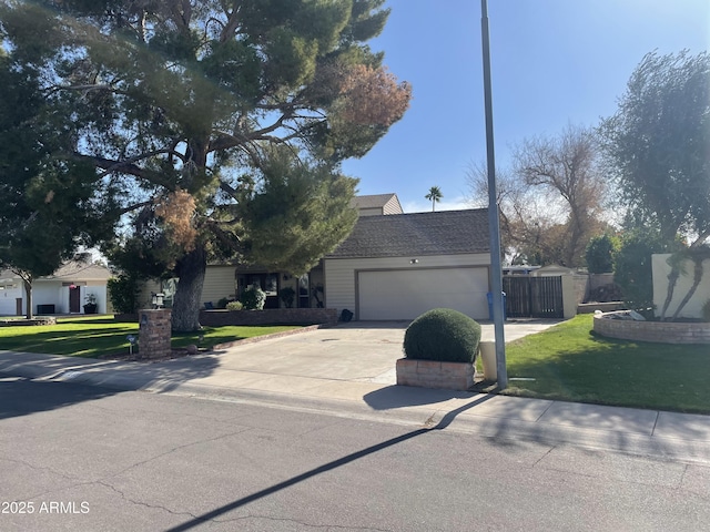 view of front of property with a garage and a front lawn