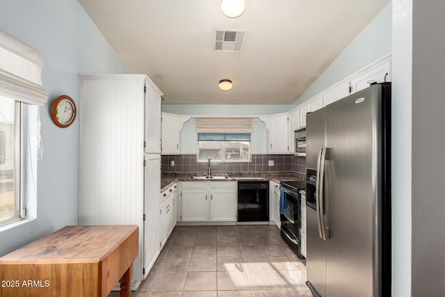 kitchen featuring black appliances, white cabinets, sink, decorative backsplash, and light tile patterned floors