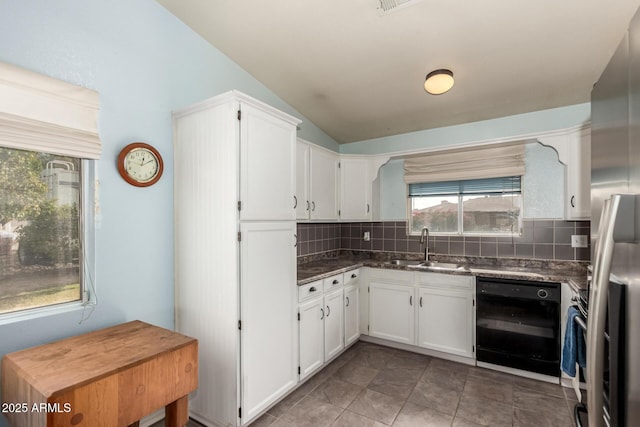 kitchen with white cabinets, decorative backsplash, sink, and vaulted ceiling