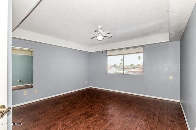 empty room featuring ceiling fan, hardwood / wood-style floors, and a textured ceiling