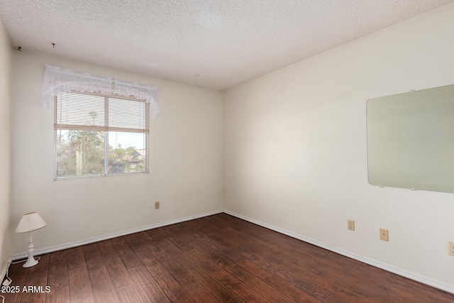 spare room with hardwood / wood-style flooring and a textured ceiling