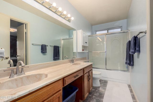 full bathroom featuring vanity, toilet, and combined bath / shower with glass door