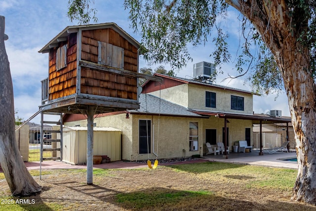 rear view of house with a patio area and central air condition unit