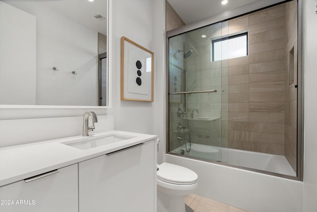 full bathroom featuring tile patterned flooring, vanity, toilet, and enclosed tub / shower combo