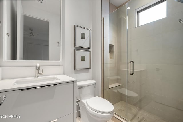 bathroom featuring vanity, toilet, and walk in shower