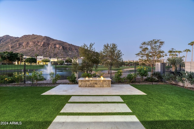 view of yard featuring a water and mountain view and a patio area