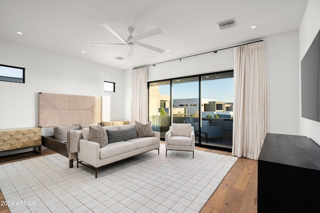 living room featuring light hardwood / wood-style floors and ceiling fan