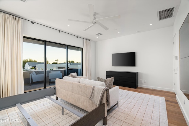 living room with light hardwood / wood-style floors and ceiling fan