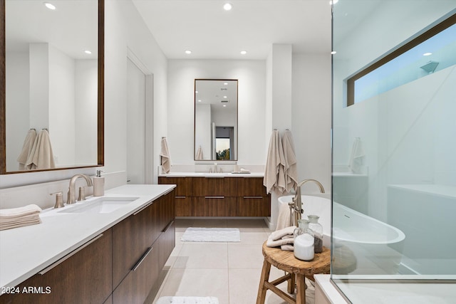 bathroom with tile patterned flooring, vanity, and separate shower and tub