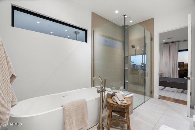 bathroom featuring tile patterned flooring and plus walk in shower