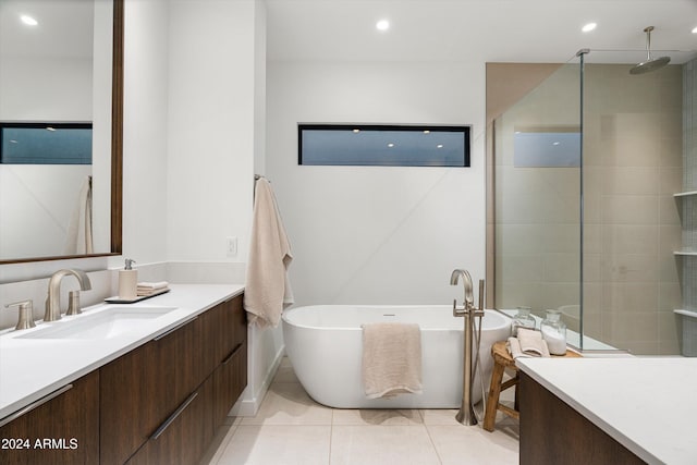 bathroom featuring vanity, tile patterned flooring, and plus walk in shower