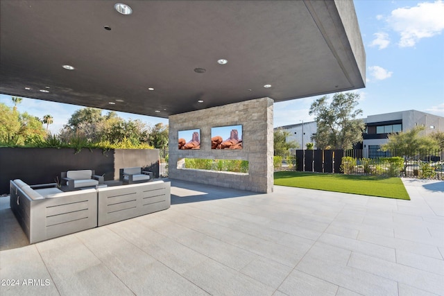 view of patio with an outdoor living space with a fireplace