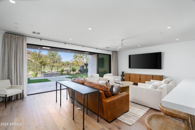 living room with ceiling fan and light hardwood / wood-style floors