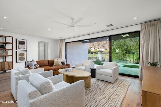 living room featuring ceiling fan and light wood-type flooring