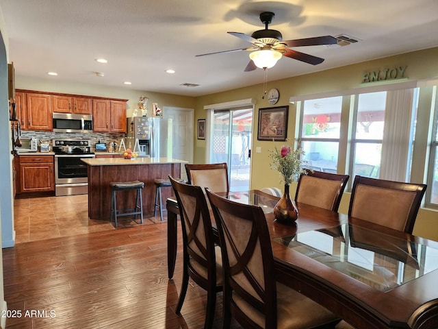 dining area with ceiling fan and light hardwood / wood-style flooring