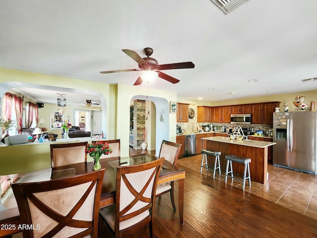 dining area with dark hardwood / wood-style floors and ceiling fan