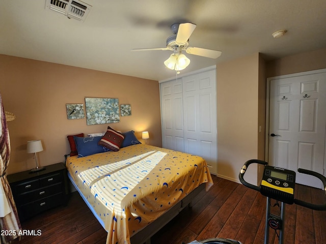 bedroom featuring dark hardwood / wood-style flooring, a closet, and ceiling fan