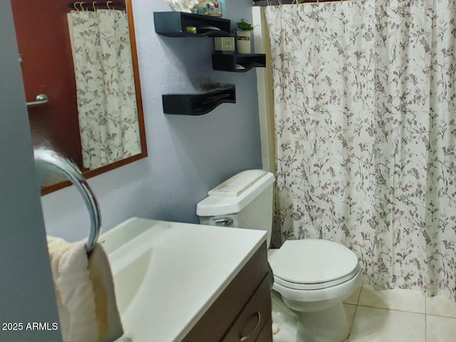 bathroom featuring tile patterned flooring, vanity, a shower with shower curtain, and toilet