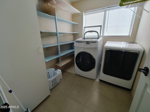 laundry area featuring separate washer and dryer and light tile patterned floors