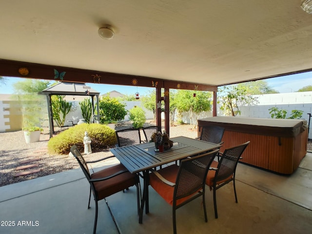 view of patio / terrace with a hot tub