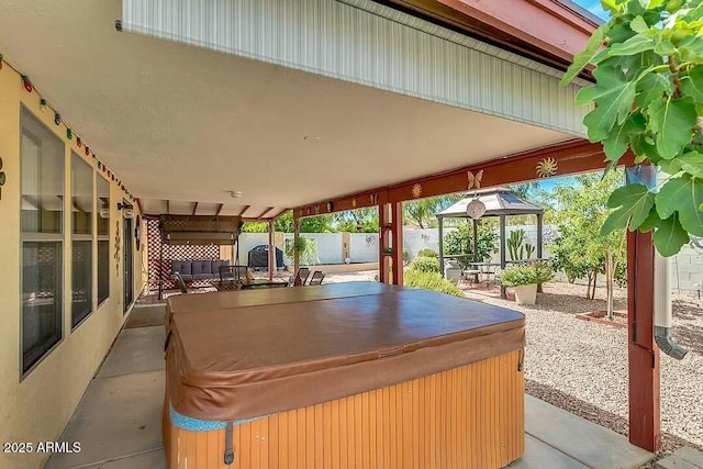 view of patio / terrace featuring a gazebo and a hot tub