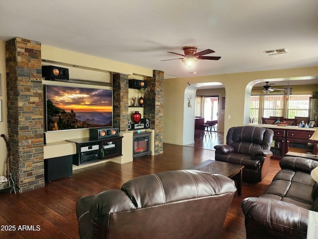 living room featuring dark hardwood / wood-style flooring and ceiling fan