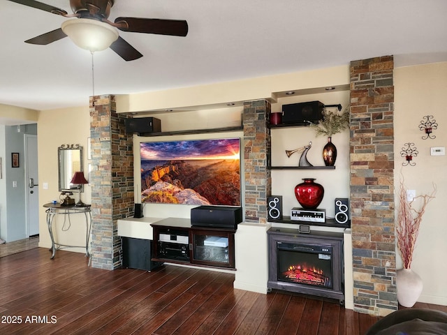 living room with dark hardwood / wood-style flooring, a fireplace, and ceiling fan