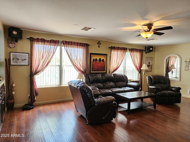 living room with ceiling fan and dark hardwood / wood-style flooring