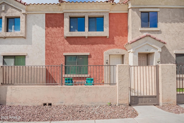 1950 N Center St Unit 115, Mesa, AZ 85201 - multi unit property featuring a gate, stucco siding, and a tile roof