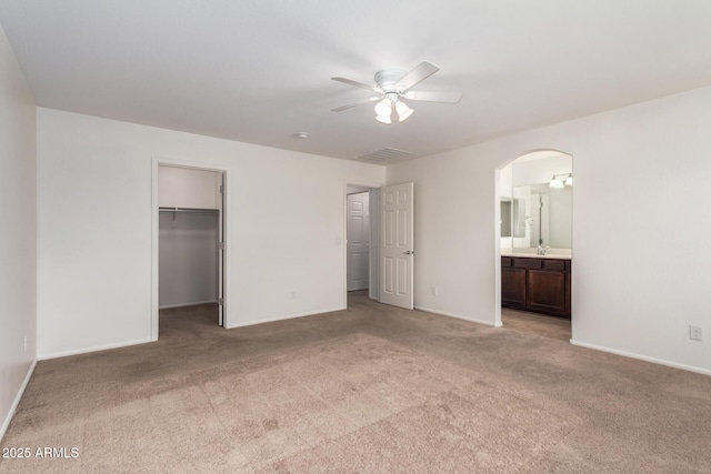 1950 N Center St Unit 115, Mesa, AZ 85201 - unfurnished bedroom featuring arched walkways, light colored carpet, baseboards, and a spacious closet