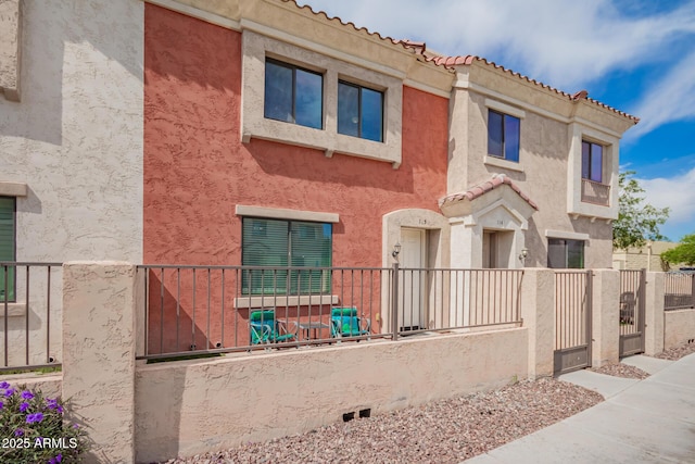 1950 N Center St Unit 115, Mesa, AZ 85201 - view of front of home featuring fence, stucco siding, and a tiled roof