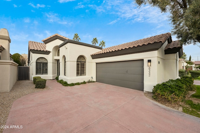 mediterranean / spanish house with a garage