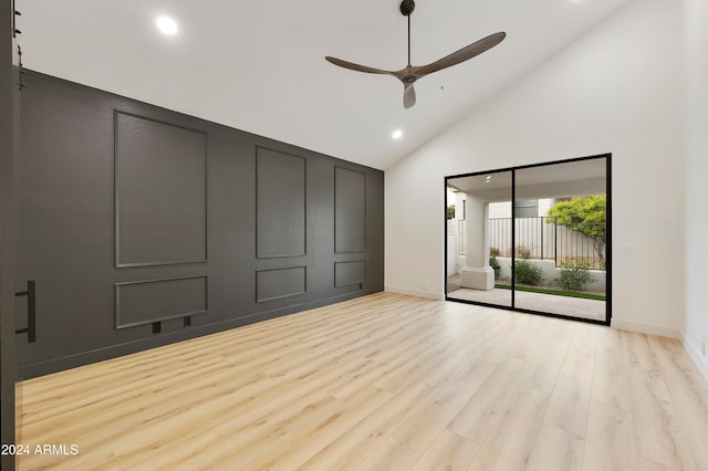 unfurnished bedroom featuring high vaulted ceiling, ceiling fan, light wood-type flooring, and access to outside