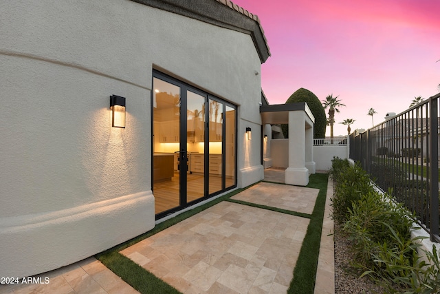 view of patio terrace at dusk