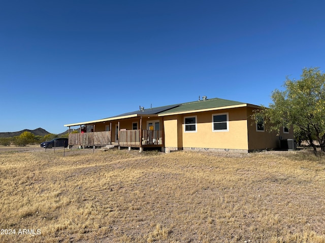 back of property featuring a deck and central air condition unit