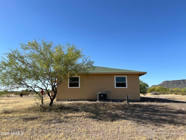 back of property featuring central AC unit