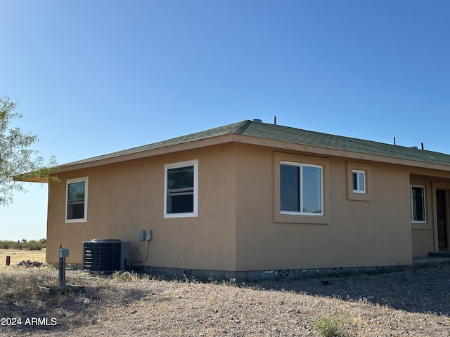 view of property exterior with central AC