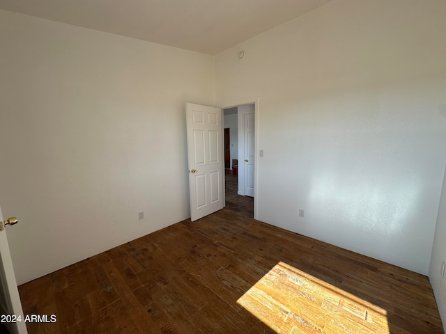 unfurnished room featuring dark wood-type flooring