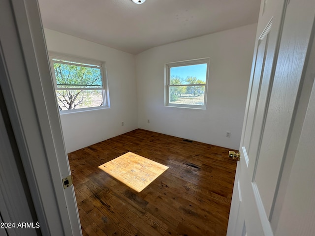 unfurnished room with dark hardwood / wood-style floors
