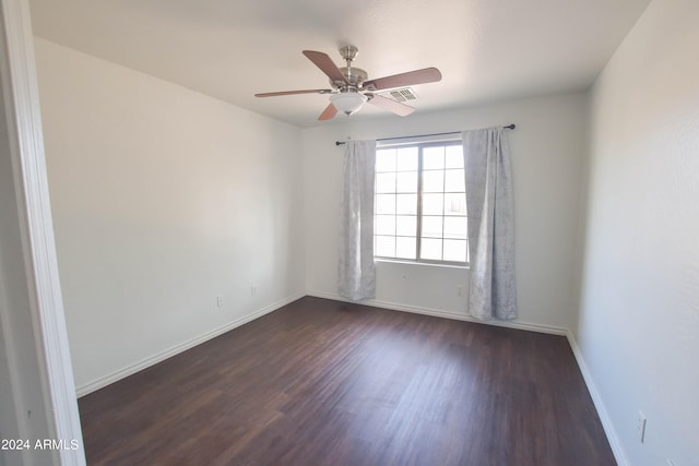 spare room featuring ceiling fan and dark hardwood / wood-style floors