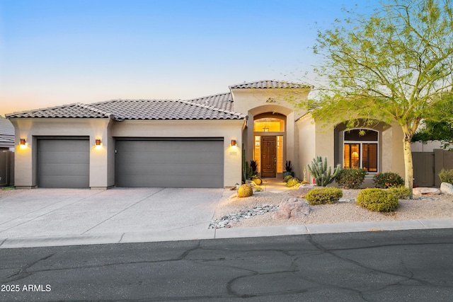 mediterranean / spanish home featuring a garage