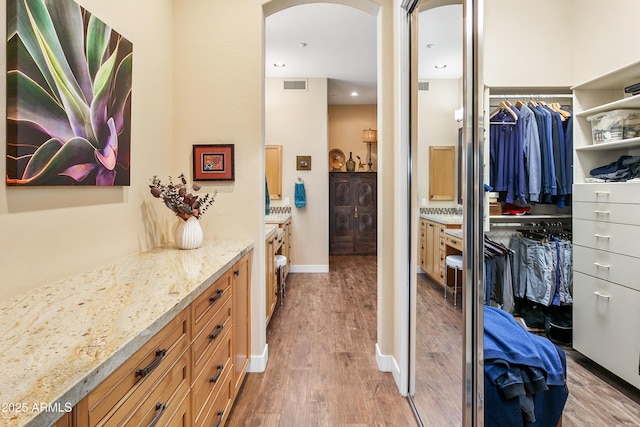 bathroom with vanity and hardwood / wood-style floors