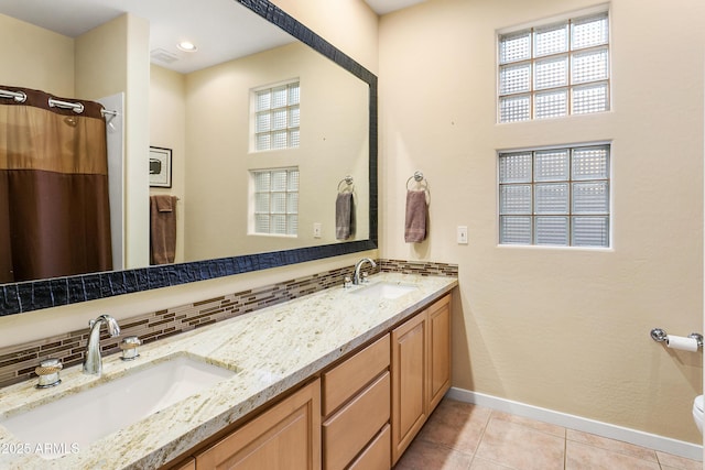 bathroom featuring tile patterned flooring, toilet, vanity, a shower with curtain, and backsplash