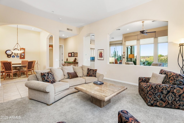 living room featuring ceiling fan and light tile patterned floors