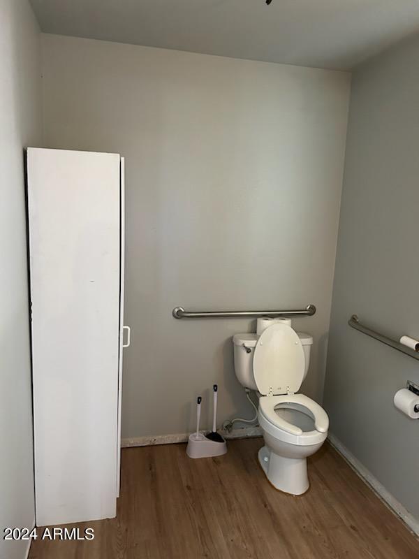 bathroom featuring wood-type flooring and toilet