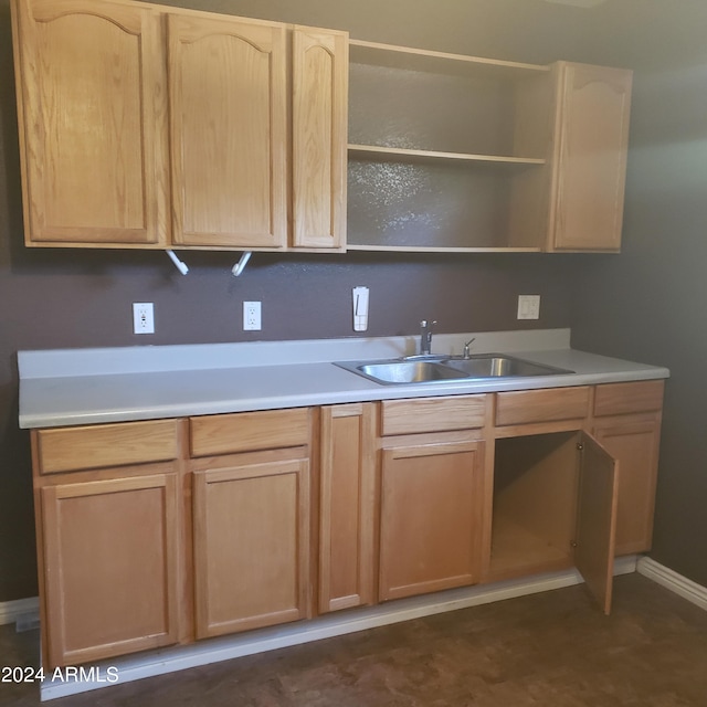 kitchen with light brown cabinetry and sink