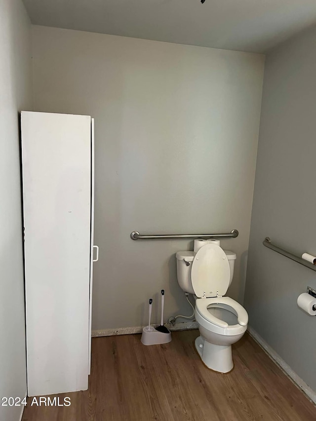 bathroom with hardwood / wood-style floors and toilet