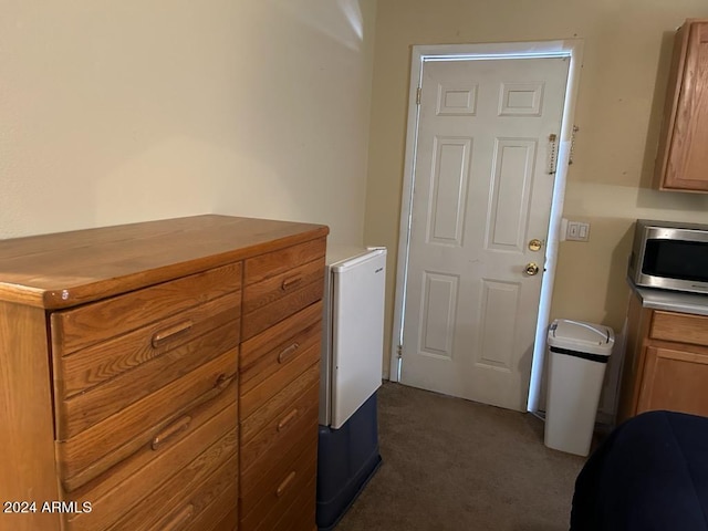 interior space with dark colored carpet